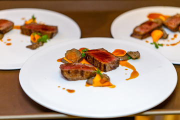 Beautifully presented dish of meat and vegetables. Tasty grilled meat sauce. Appetizing and healthy food. Photo for culinary magazines, websites and backgrounds.