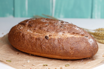Homemade Black bread. Bread of rye dough on a craft paper. Rye bread for dinner. Fresh fragrant delicious homemade pastries.