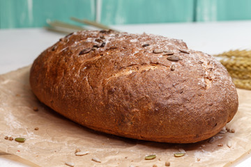 Homemade Black bread. Bread of rye dough on a craft paper. Rye bread for dinner. Fresh fragrant delicious homemade pastries.