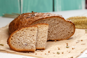 Homemade Black bread. Bread of rye dough on a craft paper. Rye bread for dinner. Fresh fragrant delicious homemade pastries.