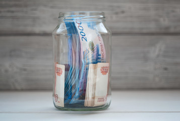 Russian banknotes in a glass jar
