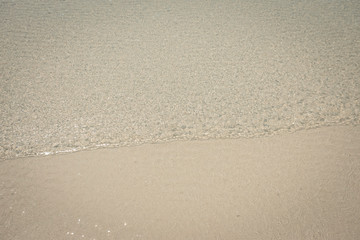 droped sungrass and small waves lapped the beach