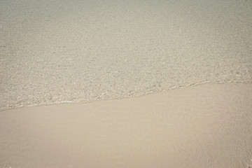 droped sungrass and small waves lapped the beach