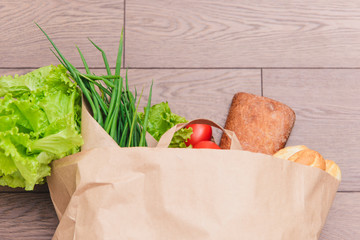 beautiful smiling woman holding a bag of groceries, standing on an isolated white background