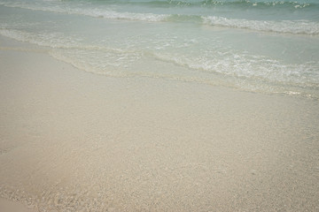 Fototapeta na wymiar droped sungrass and small waves lapped the beach