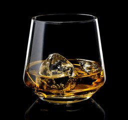 glass of whiskey with ice on a black background