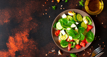 Fresh vegetable salad with mozzarella and basil served with olive oil and sea salt. Mediterranean, Spanish, Italian cuisine. Top view. Copy space