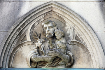 Saint Joseph holding child Jesus, headstone on Mirogoj cemetery in Zagreb, Croatia 