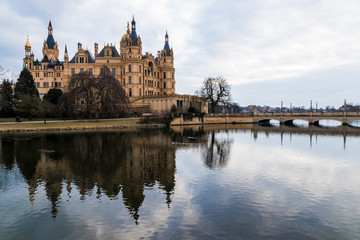 Fototapeta na wymiar Schwerin, Germany. Schwerin Castle Palace (Schweriner Schloss), reflected on Schweriner See lake, a World Heritage Site in Mecklenburg-West Pomerania