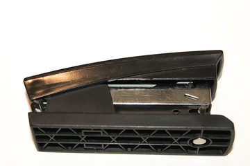 stapler stationery on a black background in male hands