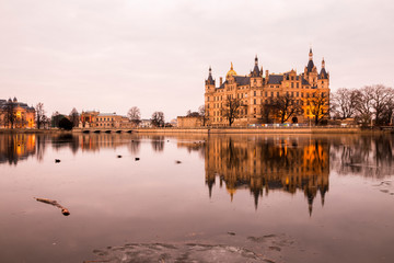 Fototapeta na wymiar Schwerin, Germany. Schwerin Castle Palace (Schweriner Schloss), reflected on Schweriner See lake, a World Heritage Site in Mecklenburg-West Pomerania