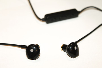 bluetooth headphones in hand on white background close on top