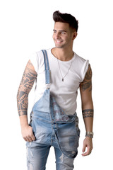 Fototapeta premium Young man wearing denim overalls and white t-shirt isolated in studio shot against white