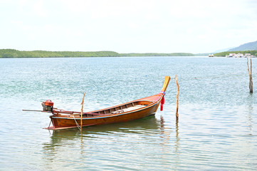 Fototapeta premium Small wooden boat in the sea