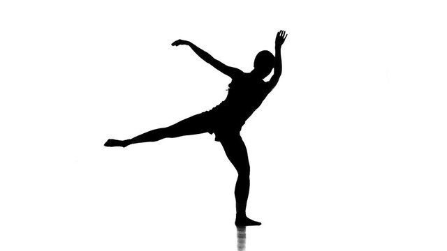 young ballerina dancing modern ballet,contemporary dance, black silhouette on white background,slow motion