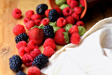 Different berries on a wooden background