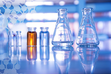glass flask and blue and orange solution in vial for medical science and education experiment...