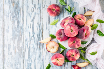 Ripe and Juicy peaches on table with fresh juice in background