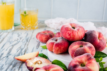 Ripe and Juicy peaches on table with fresh juice in background