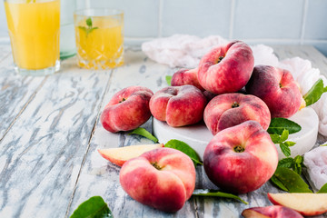 Ripe and Juicy peaches on table with fresh juice in background