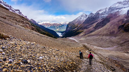 Obraz premium Hiking in the Mountains surrounding the moraines of Victoria Glacier on the hiking trail to the Plain of Six Glaciers at Lake Louise in Banff National Park, Alberta, Canada