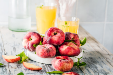 Ripe and Juicy peaches on table with fresh juice in background
