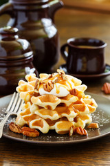 Homemade waffles with caramel and pecans.