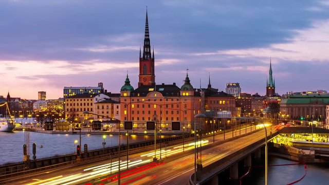 Stockholm, Sweden. Time-lapse of Gamla Stan in Stockholm, Sweden with landmarks like Riddarholm Church during the sunset. View of old buildings and car traffic at the bridge, panning video