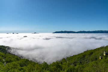 Panorama view from Unkai Terrace in summer time sunny day. Take the cable car at Tomamu Hoshino Resort, going up to see the sea of clouds. Shimukappu village, Hokkaido, Japan