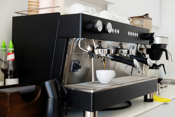 Close up of modern beautiful coffee machine with vintage style black and chrome metal texture design. Macro shot of coffee making equipment. Copy space, background.