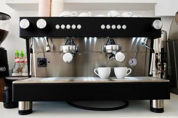 Close up of modern beautiful coffee machine with vintage style black and chrome metal texture design. Macro shot of coffee making equipment. Copy space, background.