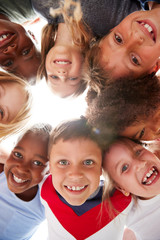 Group Of Multi-Cultural Children With Friends Looking Down Into Camera