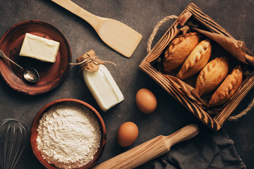 Baking background, ingredients for cooking pies, flour, butter, milk, eggs. Traditional Russians baked patties, pirozhki. Overhead,flat lay.
