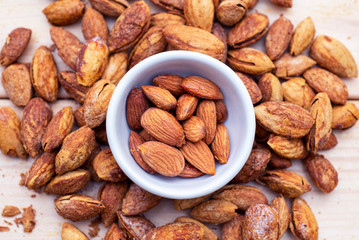 Almonds on wood background texture.