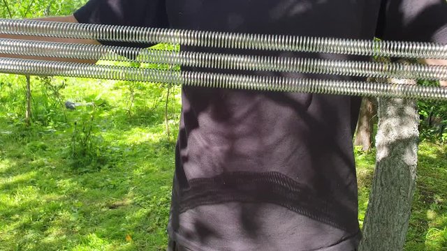 A man does exercises with an expander. Training with an expander.