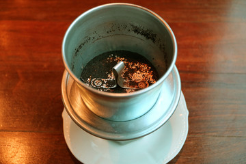 Drip filter called a phin on coffee cup after finished the preparation of Vietnamese drip coffee 