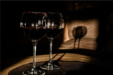 Two glasses of red wine with shadows