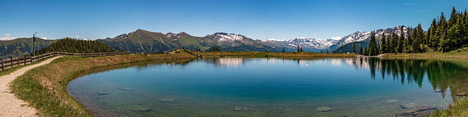 High resolution stitched panorama of a lake with reflections and a beautiful alpine view at Rauris, Salzburg, Austria