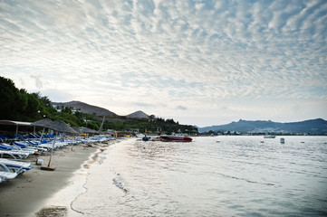 Fototapeta premium Empty beach in Bodrum, Turkey. Blue sky, white sand, a dream holiday place to relax, snorkel and rest.