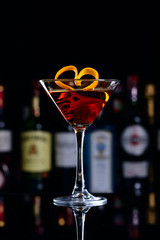 classic manhattan cocktail decorated with orange hearts, romantic cocktail