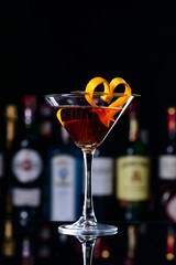 classic manhattan cocktail decorated with orange hearts, romantic cocktail