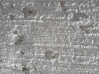 Rough concrete wall covered with plaster. Grunge background. 