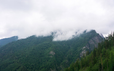 Fototapeta na wymiar mountain peaks in misty clouds