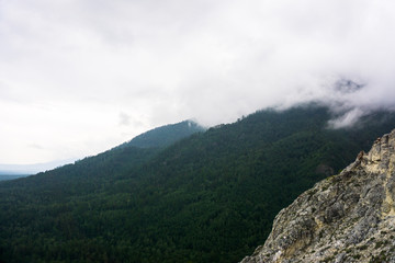 mountain peaks in misty clouds