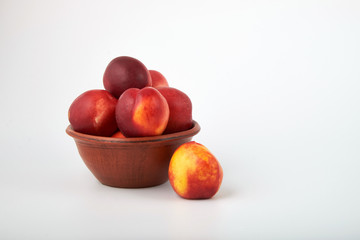 Ripe juicy nectarines isolated on white background