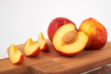 Ripe juicy nectarines isolated on white background