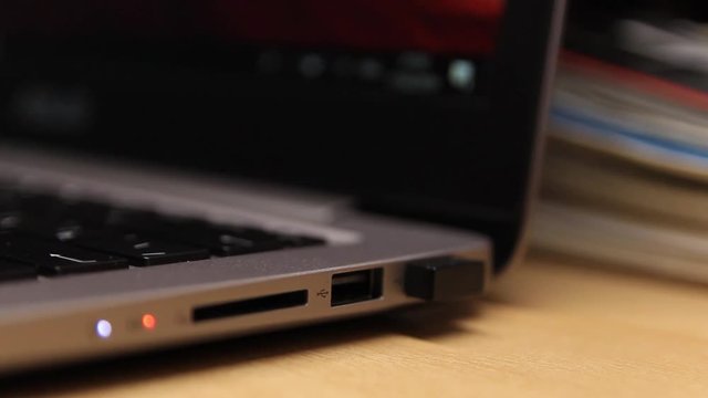 Removing a flash drive from a laptop. Close-up. A laptop. Technology.