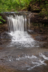 Obraz premium Glen Helen Cascades - The Cascades waterfall, on Birch Creek, splashes into a rocky ravine along the Innman Trail at Glen Helen Nature Preserve in Yellow Springs, Ohio.