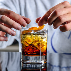 bartender prepares a classic Negroni cocktail