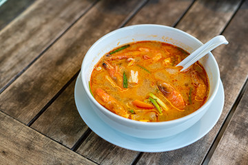 Tom Yam Kung, Thai cuisine. on a wooden table.
